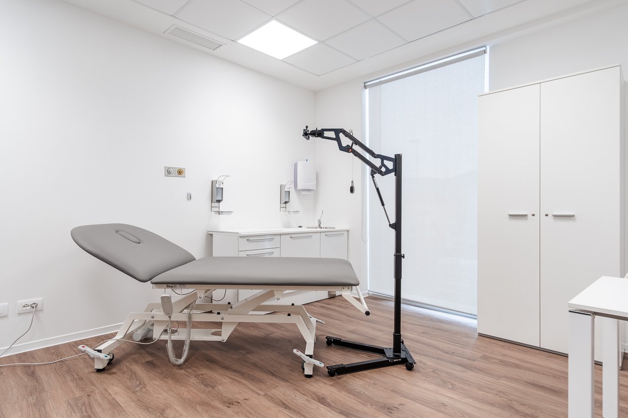 Illustrative clinical examination room with examination table and medical equipment